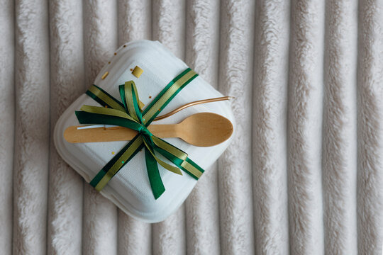 Gift-wrapped takeout box with wooden utensils