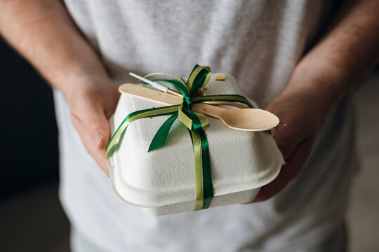 Takeout box gift with green ribbon and wooden spoon