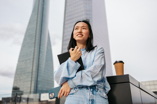 Confident Asian businesswoman in urban setting