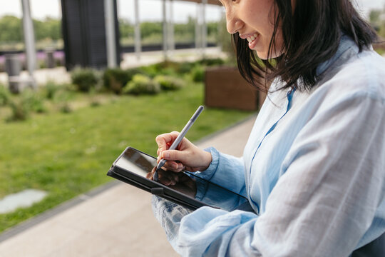Businesswoman using digital tablet outdoors