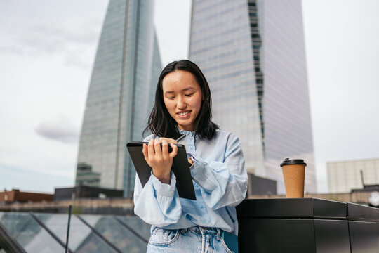 Businesswoman using tablet in urban setting