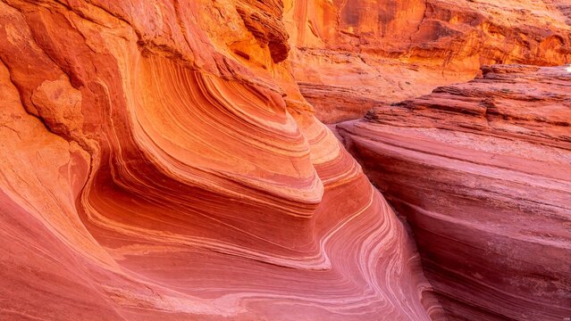 Red sandstone canyon wall texture with wind-eroded sedimentary layers