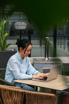Businesswoman working outdoors on laptop
