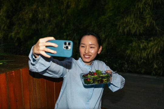 Woman enjoying a healthy salad selfie