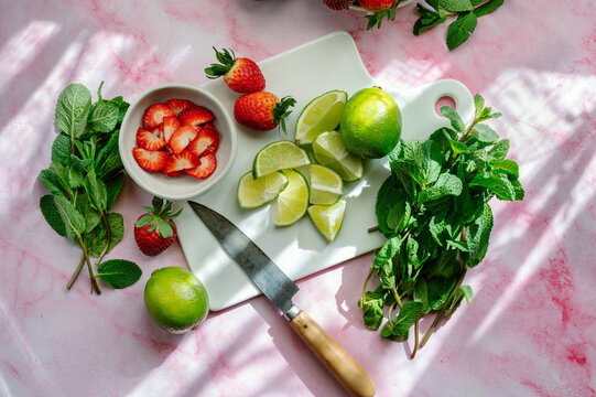 Fresh ingredients for a strawberry mojito cocktail