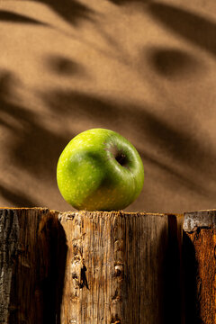 Green apple in modern still life setting