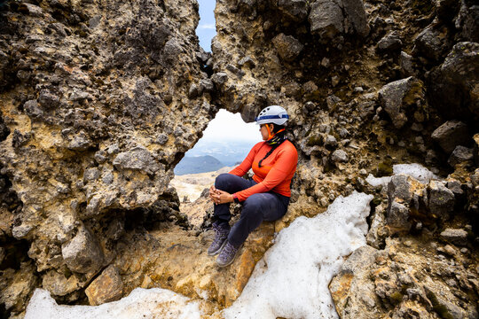 Adventurous hiker exploring rocky mountain terrain