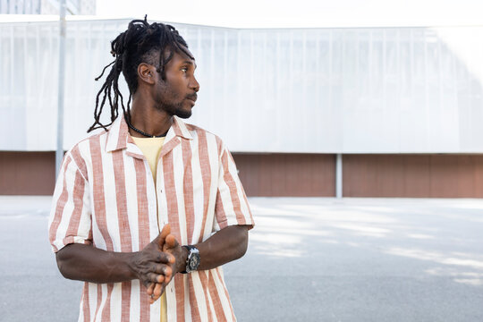 Cuban man with dreadlocks in striped shirt outdoors