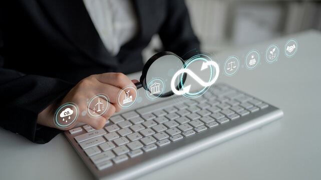 Business Professional Analyzing Digital Data with Magnifying Glass Over Keyboard and Virtual Icons Representing Technology and Strategy. Sentient.