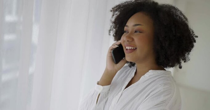 African American black woman smile use tablet smartphone in white room, Portrait beauty  girl hygge relax. Technology people connection digital online social media market.