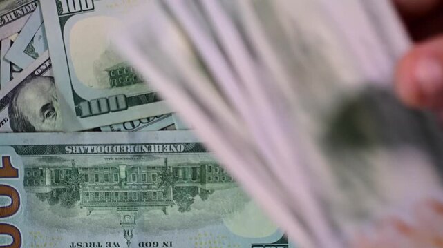 abstract close up counting money, finance, 100 dollars bills, bokeh, selective focus background video