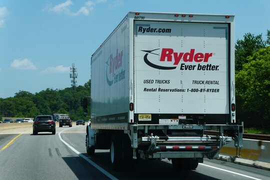 Pennsylvania, U.S.A - Jul 2, 2026 - White Ryder rental truck with branding, lift gate, contact numbers, and highway traffic under clear sky.