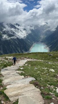 Hiking to Olpererh&uuml;tte in Austria with views of mountains and lake