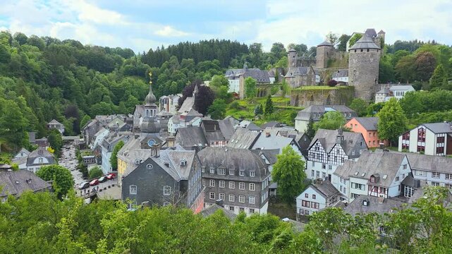 View over the picturesque medieval town and castle of Monschau in the Eifel region of western Germany. Slow panning motion.