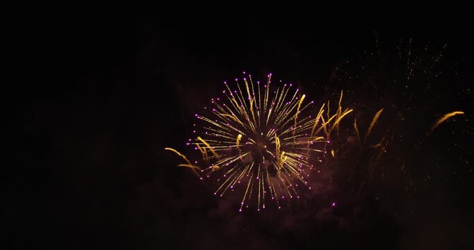 Gorgeous Fireworks Exploding In The Night Sky While Leaving Behind Lots Of Smoke