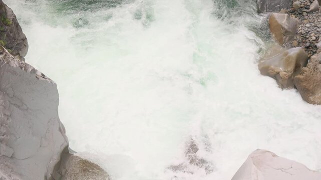 High-angle view of powerful turquoise white water river rushing and splashing through narrow rocky gorge canyon. Othello Tunnels, Hope, British Columbia, Canada.