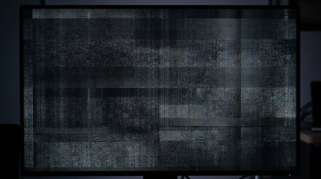 Dark monitor screen with static flicker and noise texture.