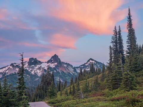 Snowy mountain peaks and evergreen forest at sunset in Washington
