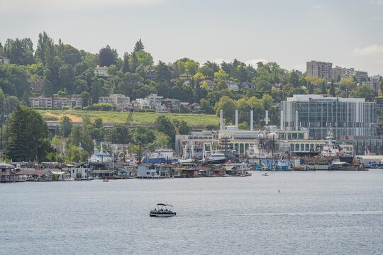 Boat on water with industrial port and hillside cityscape in Seattle