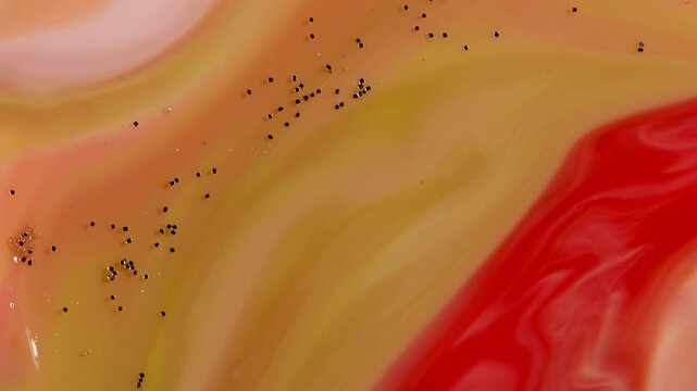 Abstract Fluid Art Macro - Swirling Yellow and Red Paint with Gold Glitter
