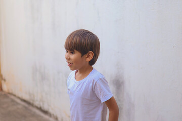 Young boy in profile portrait with natural light at home © BRUNO DIAS