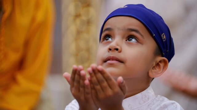 sikh boy praying with folded hands in gurdwara, gurpurab celebration devotion, guru nanak jayanti worship moment, turbaned child faith, spiritual ceremony, community prayer