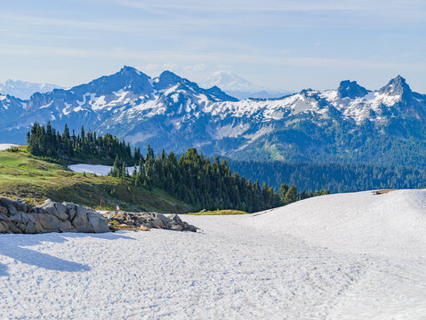 Snowy mountain landscape with evergreen forest and distant peaks in Washington