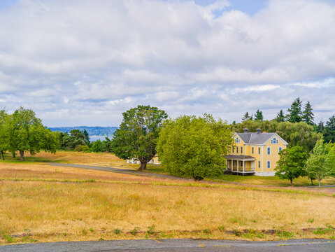 Yellow historic house with porch in Washington state