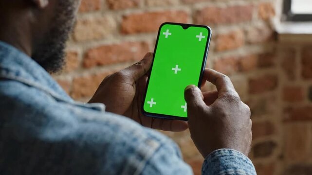 Man using smartphone with green screen chroma key for app mockup and digital marketing mobile app