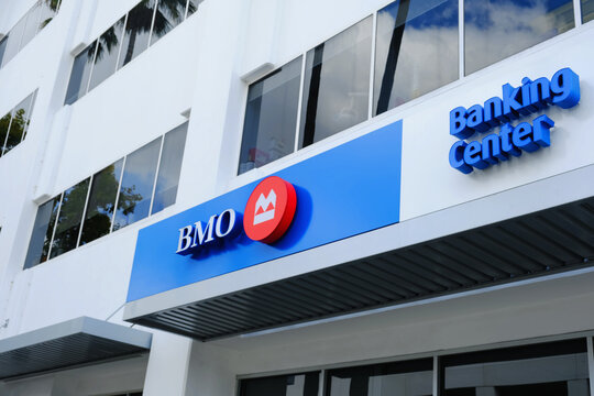 BMO bank signage on modern white commercial building facade with blue and red logo and Banking Center lettering