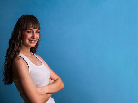 Confident young woman smiling with arms crossed