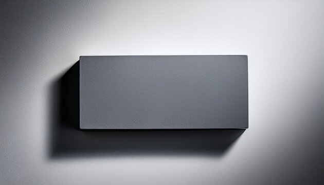 minimalist gray rectangular block on plain surface
