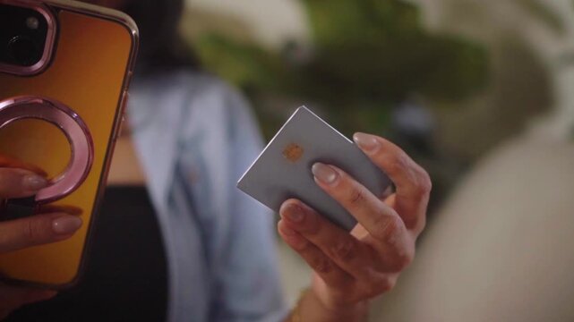 Hands woman holding credit card while online shopping