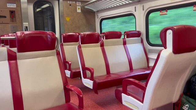 Empty commuter train car interior during travel 