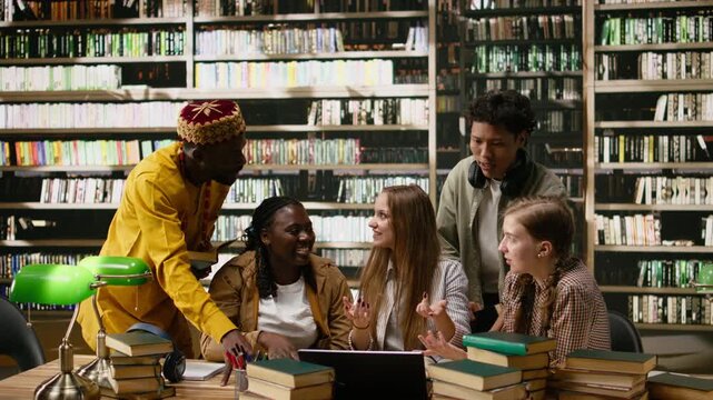 Students and adult learner uniting hands over library table after study session, smiling during collaborative learning moment with books, successful group study with confidence, for coursework.
