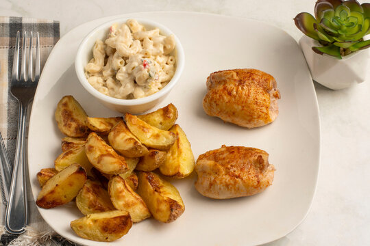 chicken thighs  with  a side of  macaroni salad