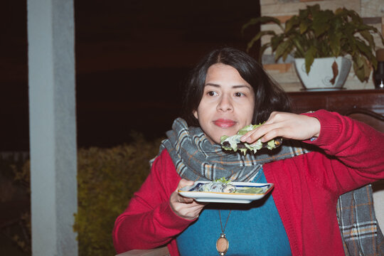 Authentic UGC Night Portrait of Casual Female Holding Plate with taco