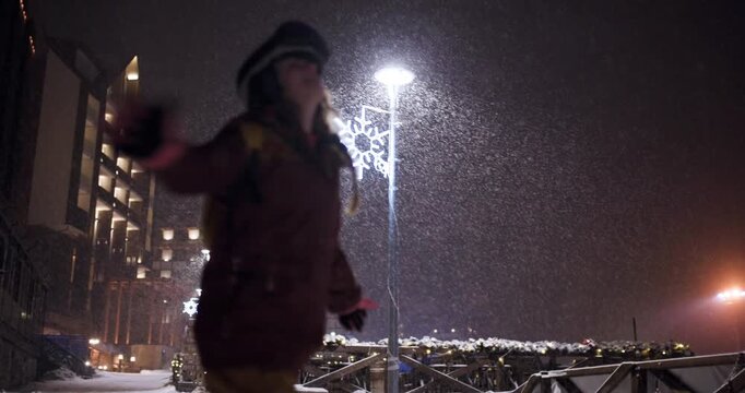 Snowboarder Girl Enjoys Snowfall at Night in Kopaonik Ski Resort