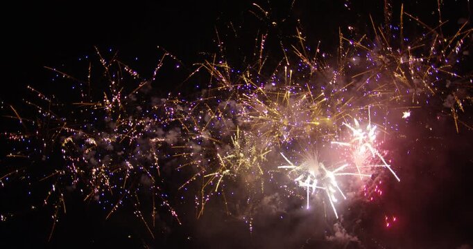 Many Beautiful Fireworks Launching Into Smokey Night Sky - Low Shot
