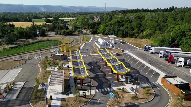 Saulce-sur-Rhone, France - June 26, 2026: Aerial drone view of Fastned electric vehicle charging station with solar canopies along the A7 motorway in Southern France, showcasing modern EV fast chargin