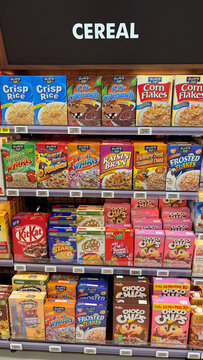 A colorful display of assorted cereal boxes in a grocery store. The shelves feature various brands and flavors, showcasing vibrant packaging and labels. Perfect for breakfast.