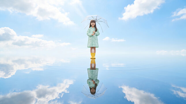 푸른 하늘 아래 장화를 신고 서 있는 여자아이 / Girl Standing in Rain Boots Under Blue Sky