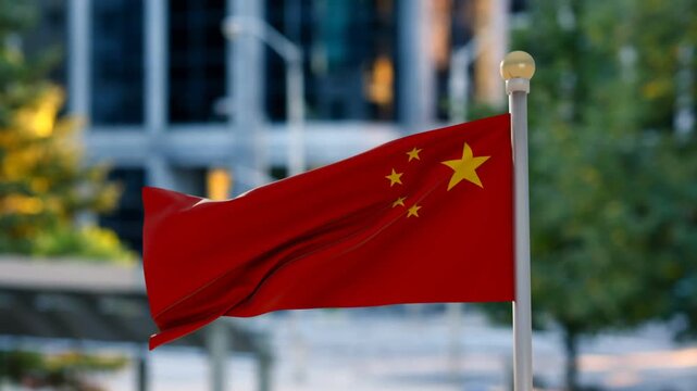 Red national flag fluttering and billowing on white pole, light breeze shifting folds and stars