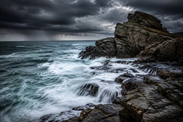 Fototapeta premium Ocean waves crashing against coastal rocks with long exposure motion.
