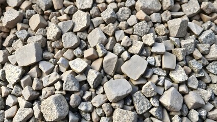 Naklejka premium Large dry heap pile of crushed building stones rocks and gravel laying on ground earth background at construction site