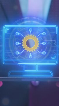 Vertical video of glowing computer monitor screen with gear network node icon. Centralized system and automation concept.