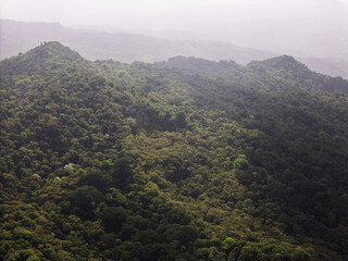 Naklejka premium Mountains covered in green forests during a cloudy day