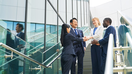 A group of multinational businesspeople shaking hands in the lobby. © metamorworks