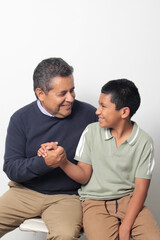 Obraz premium Latino single dad and his 12-year-old Latino son show their love to celebrate Father's Day