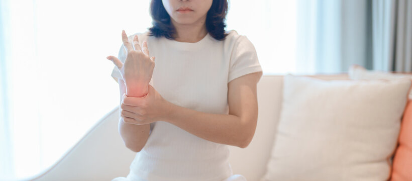 Woman having wrist pain for Carpal Tunnel Syndrome, Wrist Tendinitis, muscle ache, De Quervain s tenosynovitis, ergonomic, Hand Osteoarthritis, Office syndrome and Parkinson disease concept